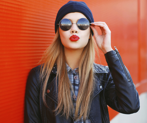Portrait of fashionable blonde girl with red lipstick wearing a
