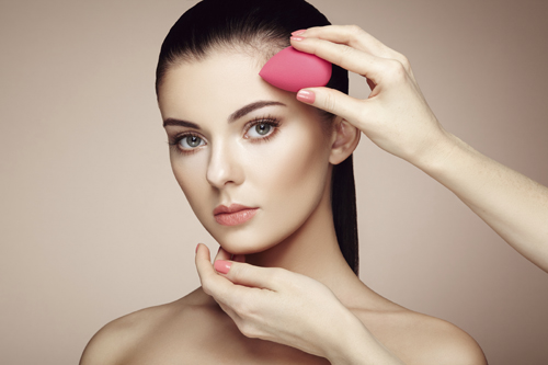 Makeup artist applies skintone